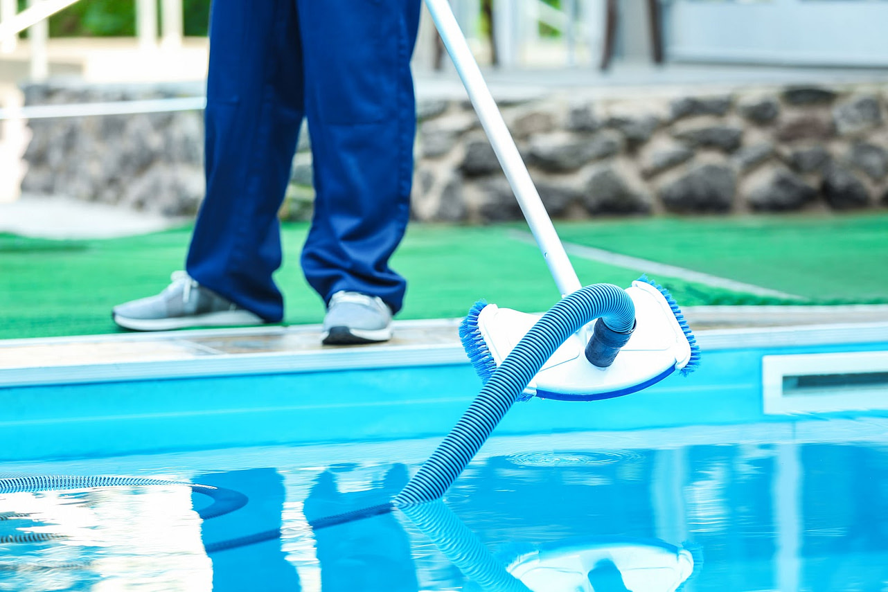 man cleaning Pool