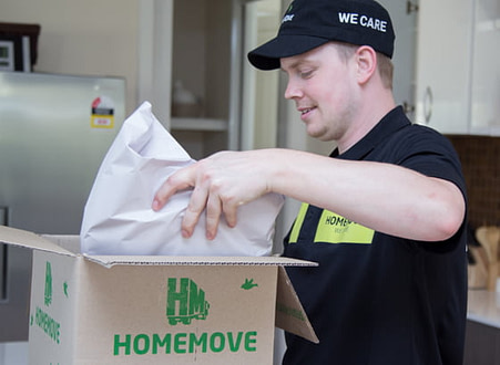 One of the HOMEMOVE Team packing