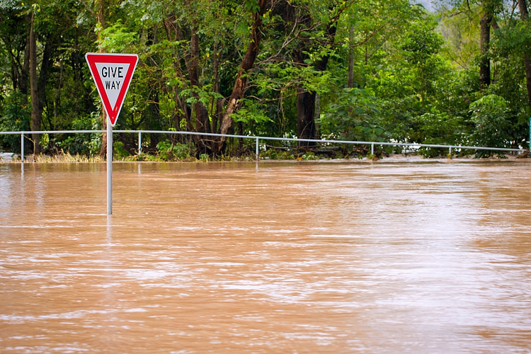 Very flooded road and give way sign in Queensland, Australia